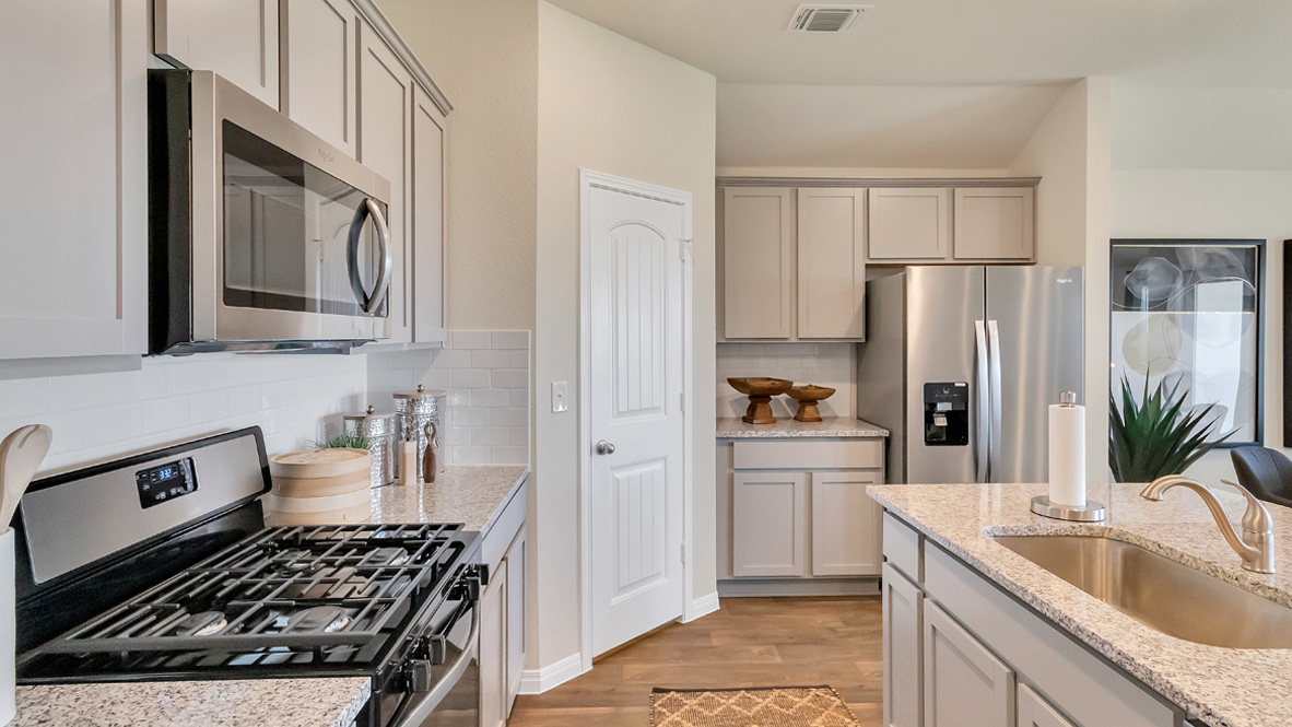 New appliances included, and a larger kitchen island, a sink, seating anchor our kitchen, pantry, near dining, living rooms