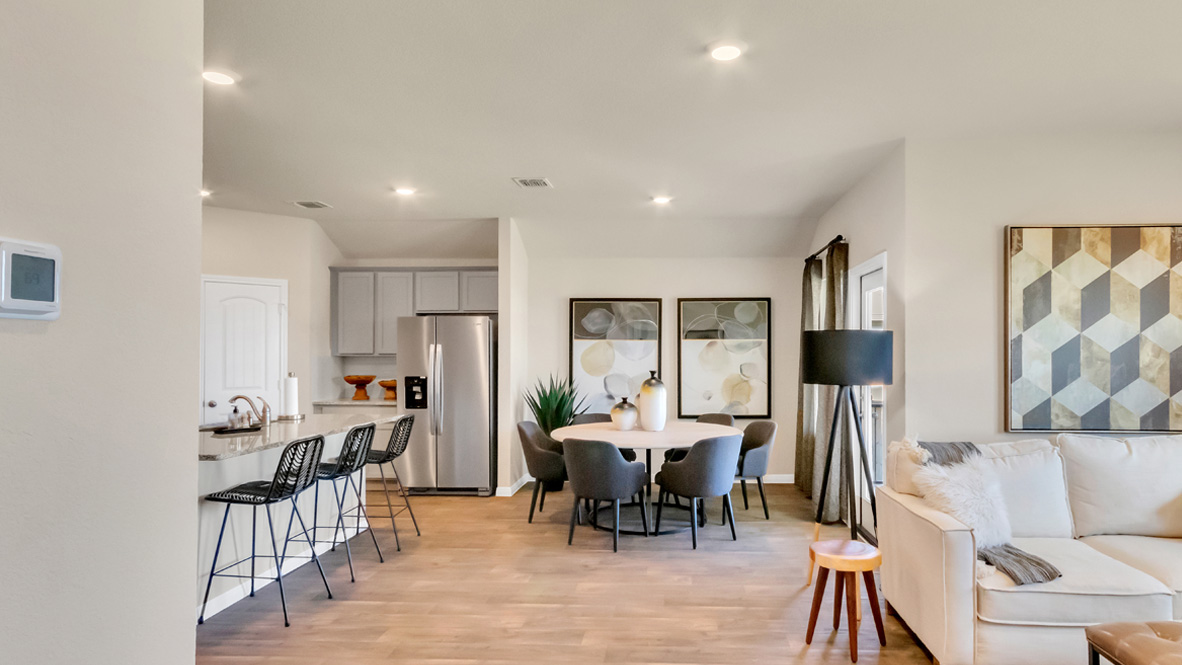 Spacious living room with view into dining and kitchen, with new appliance suite included and cabinet options at Rosenbusch Ranch