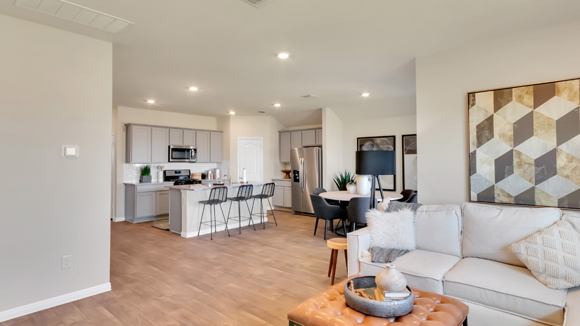 Spacious living room with view into dining and kitchen areas, and outside access at Rosenbusch Ranch