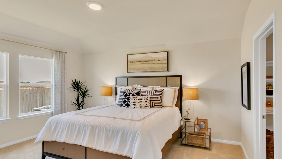 Owner’s suite offers natural window light, spa-inspired ensuite bathroom, backyard view, walk-in closet for everyday style