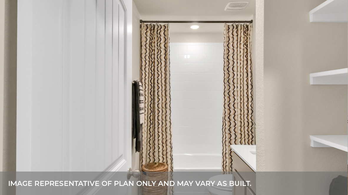 Jack and Jill bathrooom between bedroom two and bedroom three with built in shelving.