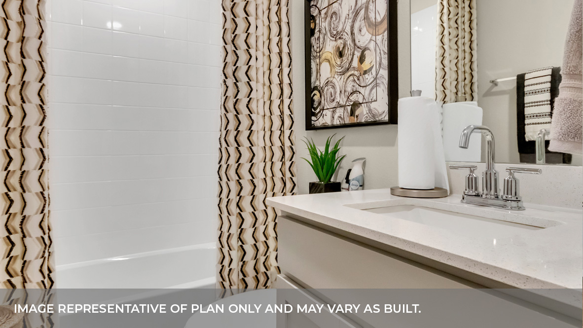Jack and Jill bathrooom between bedroom two and bedroom three with single sink light gray vanity and white granite tops with tan tile shower and tub combo.