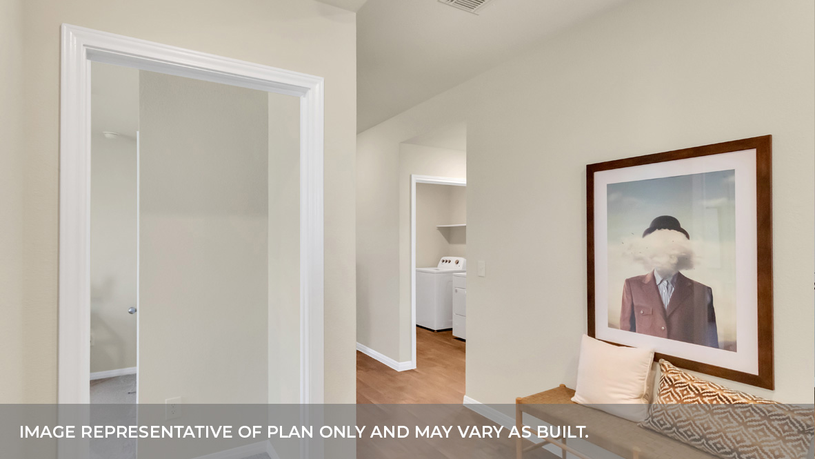 Foyer with hardwood floors with bedrrom and laundry room behind.