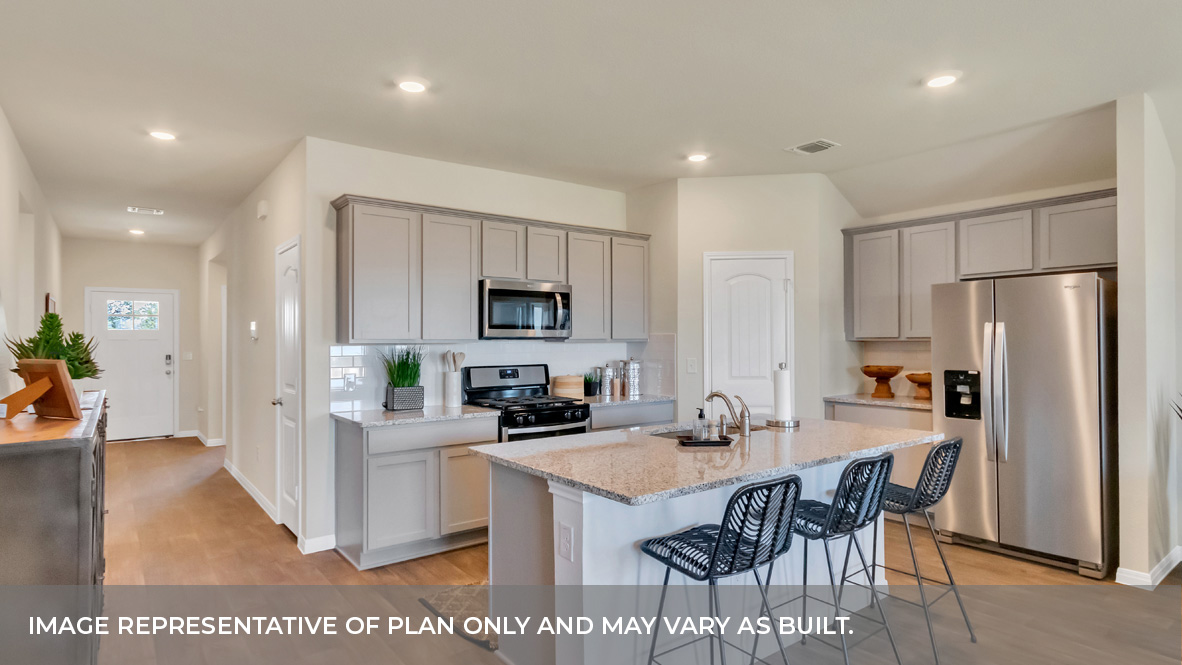 Kitchen area with front entrance and foyer behind.