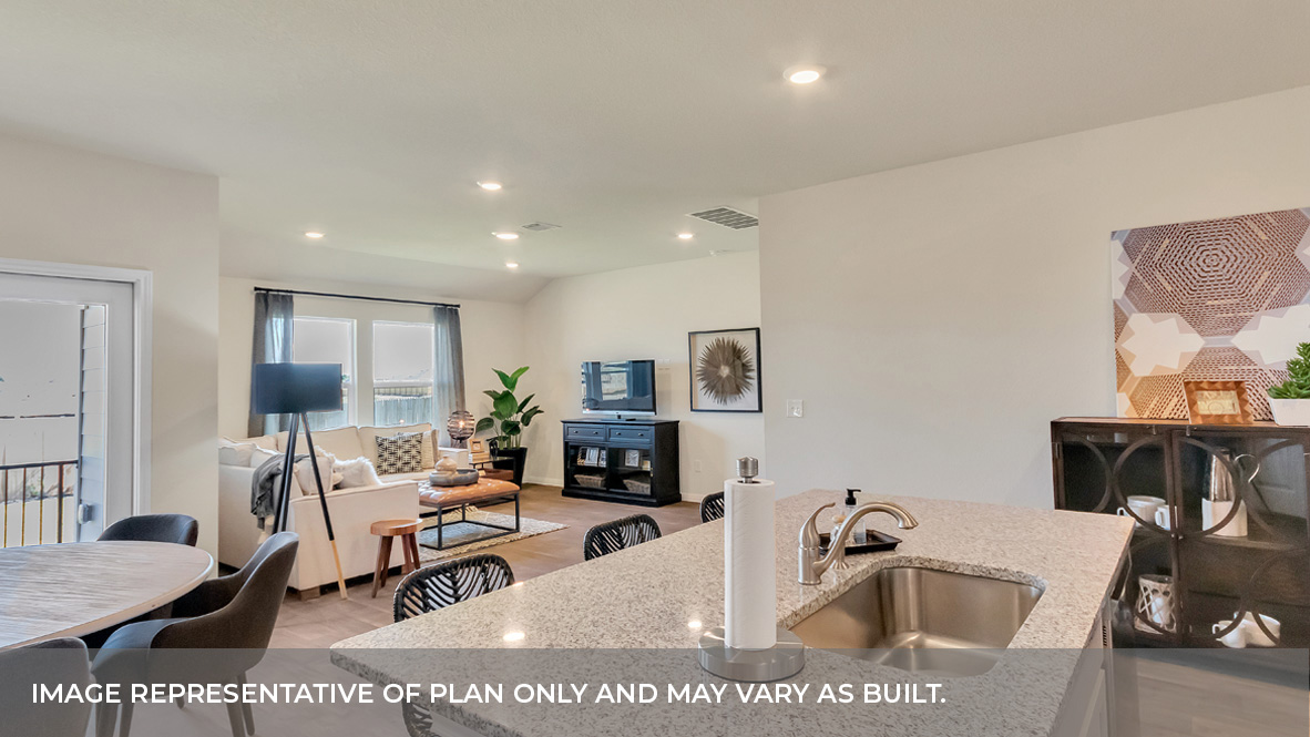 Kitchen island open concept view of the living and dining area and glass sliding back door.