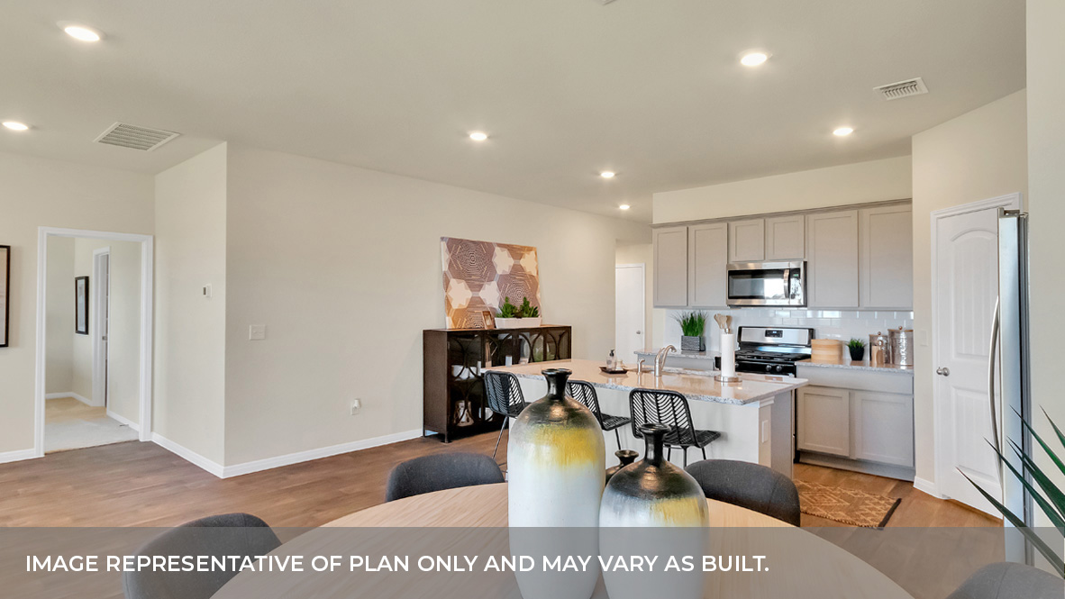 Dining area with the kitchen and foyer hall area behind.
