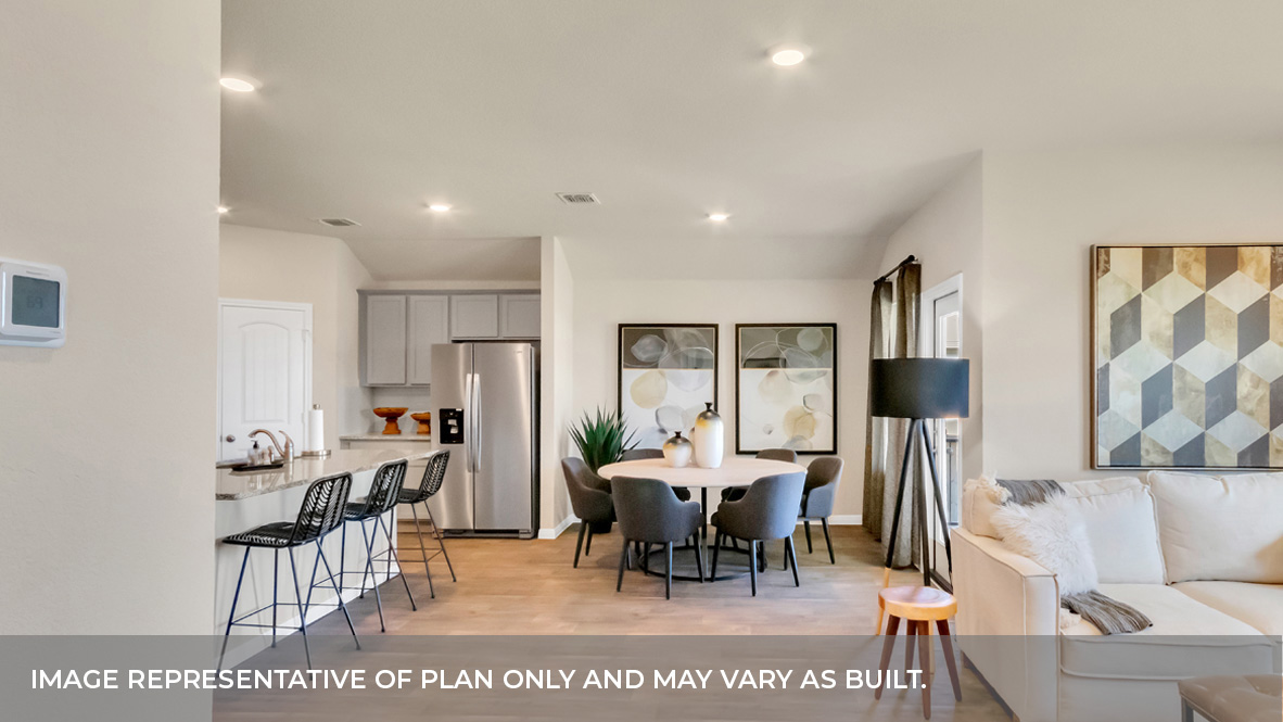 Living and dining area with large windows and glass back door.