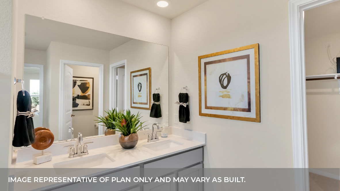 Primary bathroom featuring a double sink light gray vanity with white granite countertops and walk-in shower and with built in shelves.