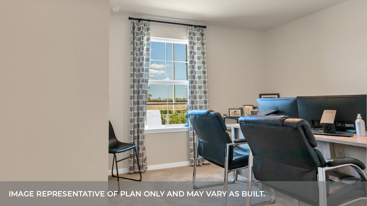 Bedroom two with carpeted floors and large single window for natural light that can be used as an office.