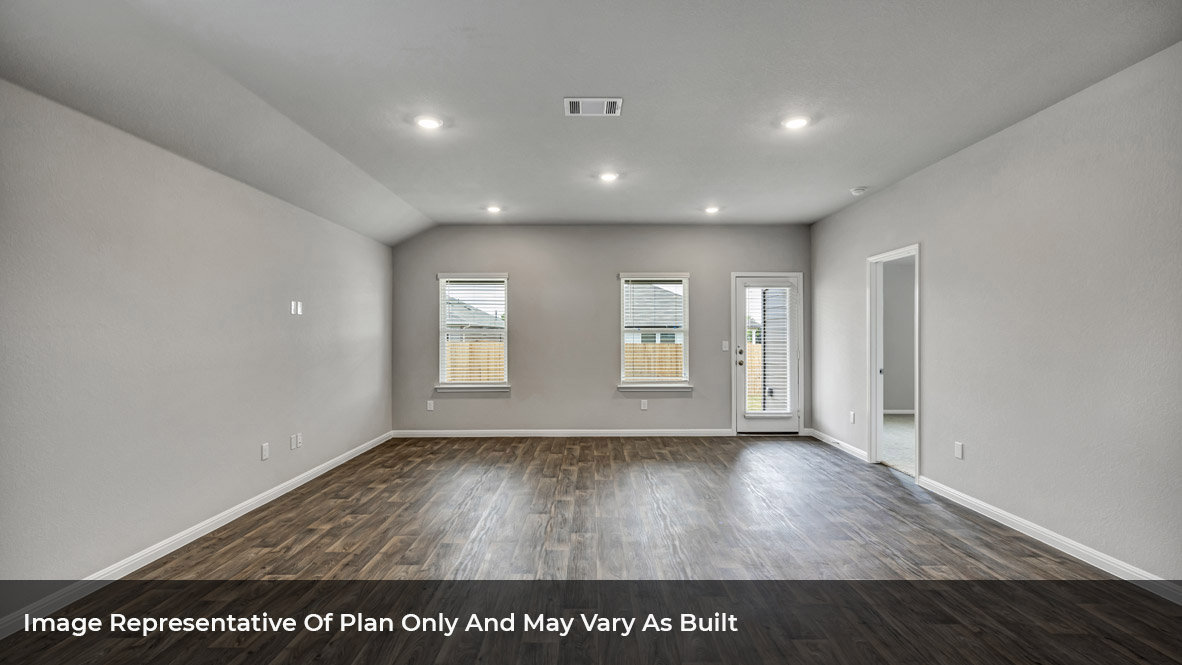 Living area with large windows and glass back door and door to a bedroom.