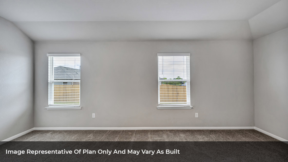 Spacious primary bedroom with two large single windows.