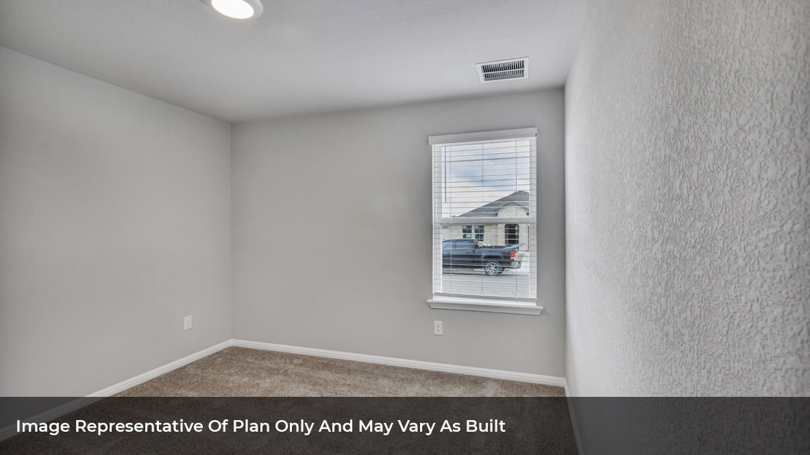 Bedroom with carpeted floors and large single window.
