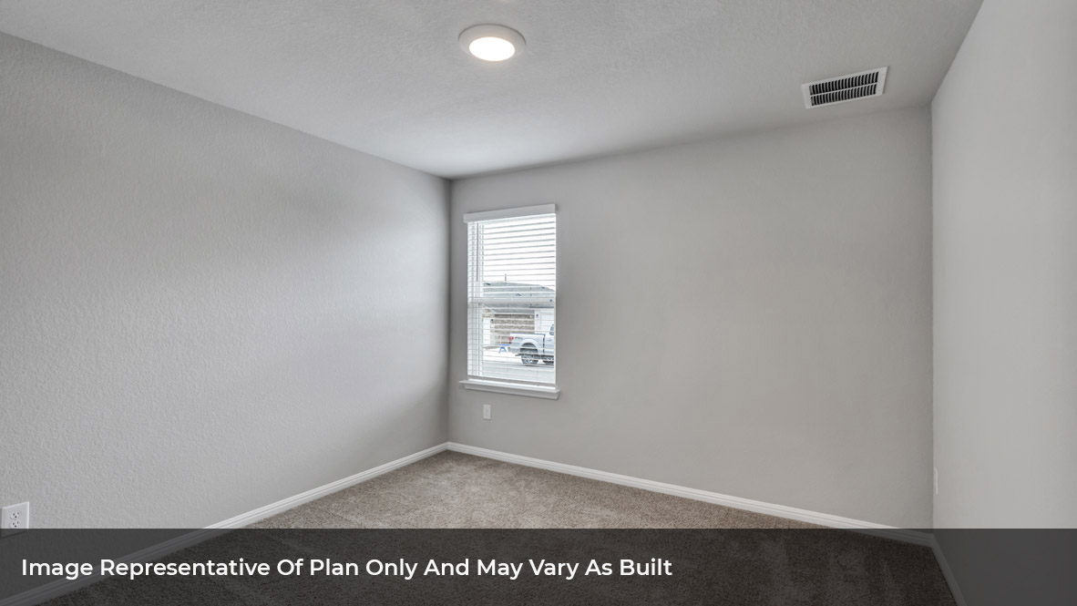 Bedroom with carpeted floors and large single window.