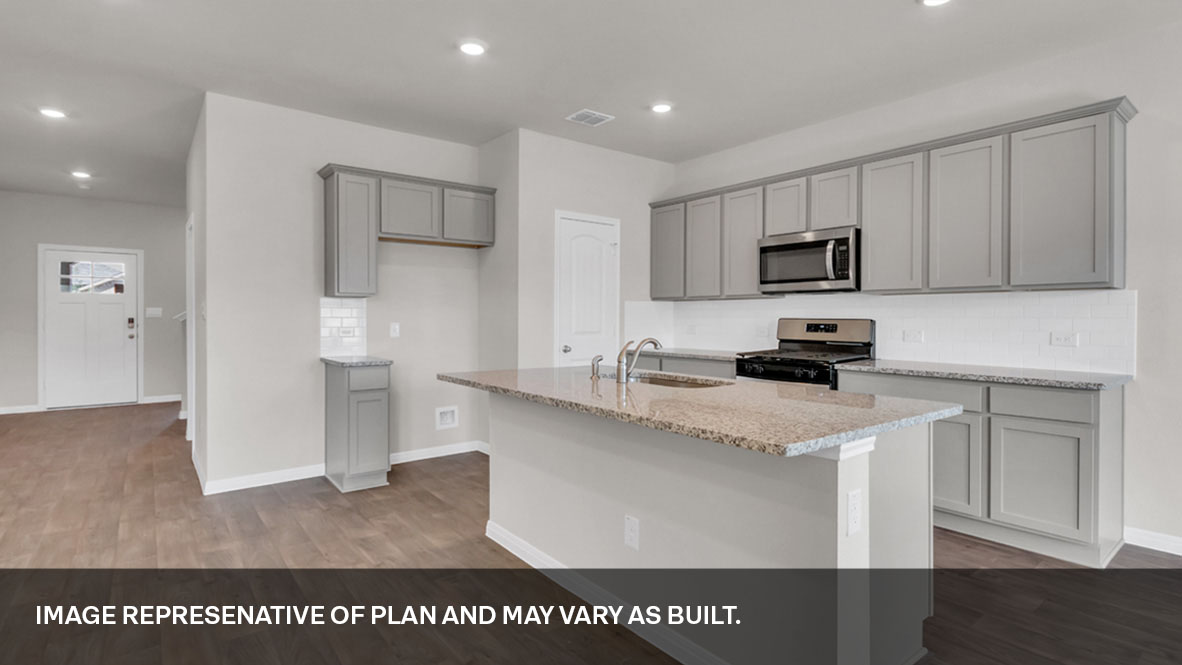 Large kitchen area with open concept view of foyer.
