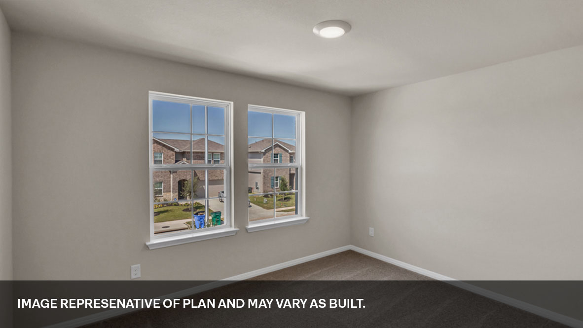Bedroom with carpeted floors and two large single windows for natural light.
