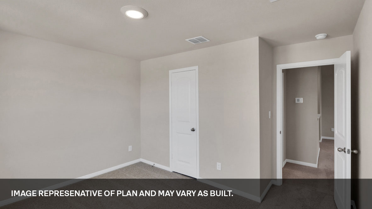 Bedroom with two large windows with entry and closet door.