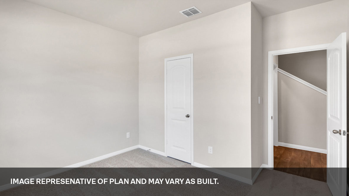 Bedroom one with closet door and entry door.