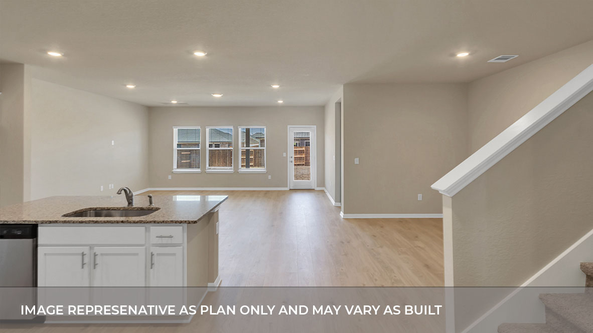 A spacious open floor plan living room, kitchen, and dining area, hardwood floors, and trey ceilings.