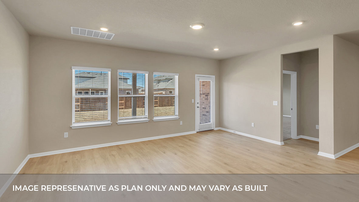 Living area with large windows and glass back door and door to a bedroom.
