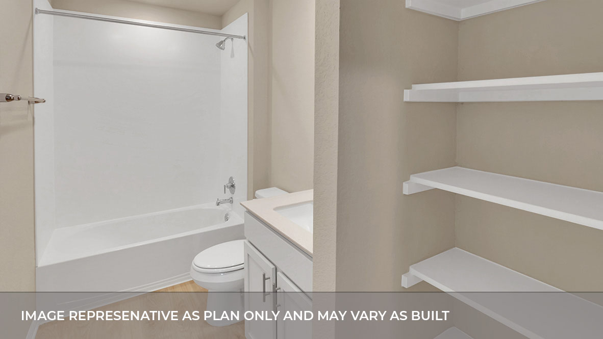 Bathroom with single sink white vanity and light tan granite tops with white tile shower and tub combo.