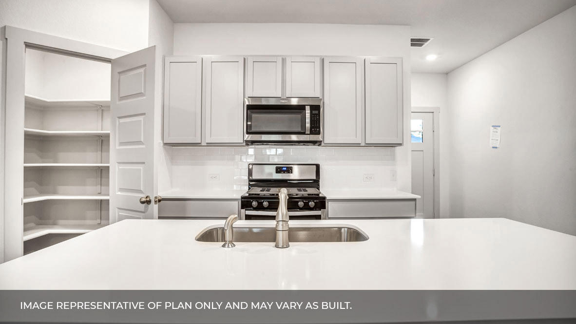 Large kitchen island with pantry in the corner.