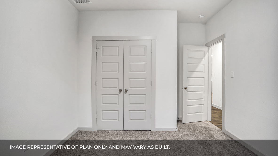 Bedroom with closet door and entry door.