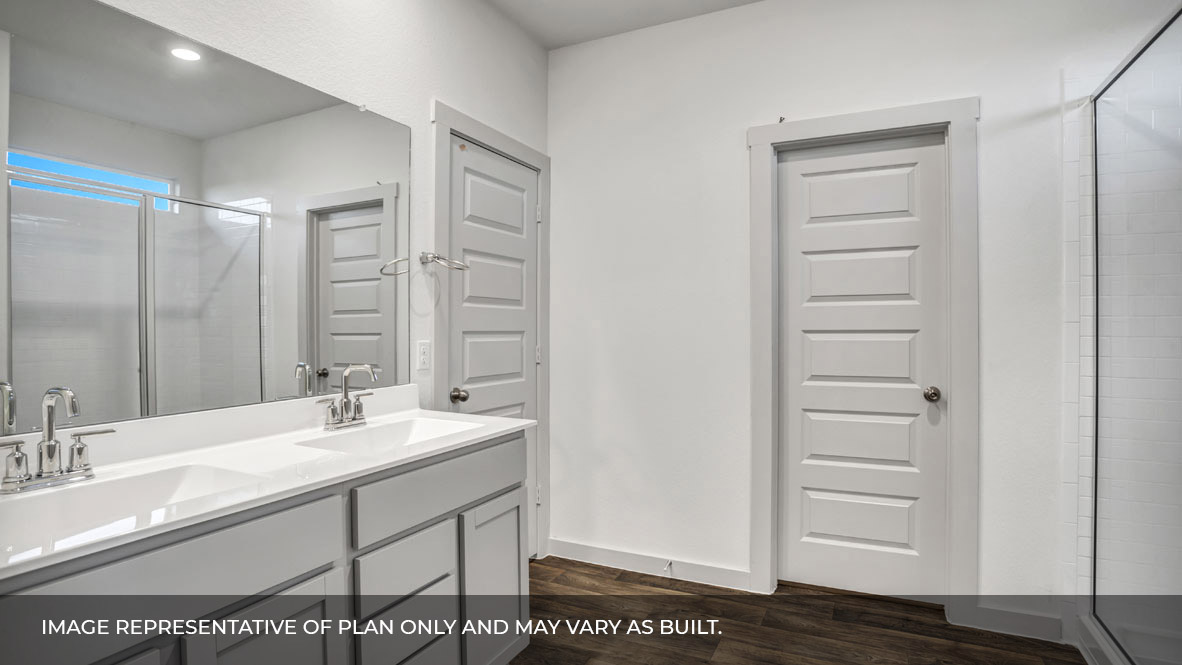 A modern bathroom featuring a double sink white vanity with white granite countertops and walk-in shower and with built in shelve with spacious walk in closet.