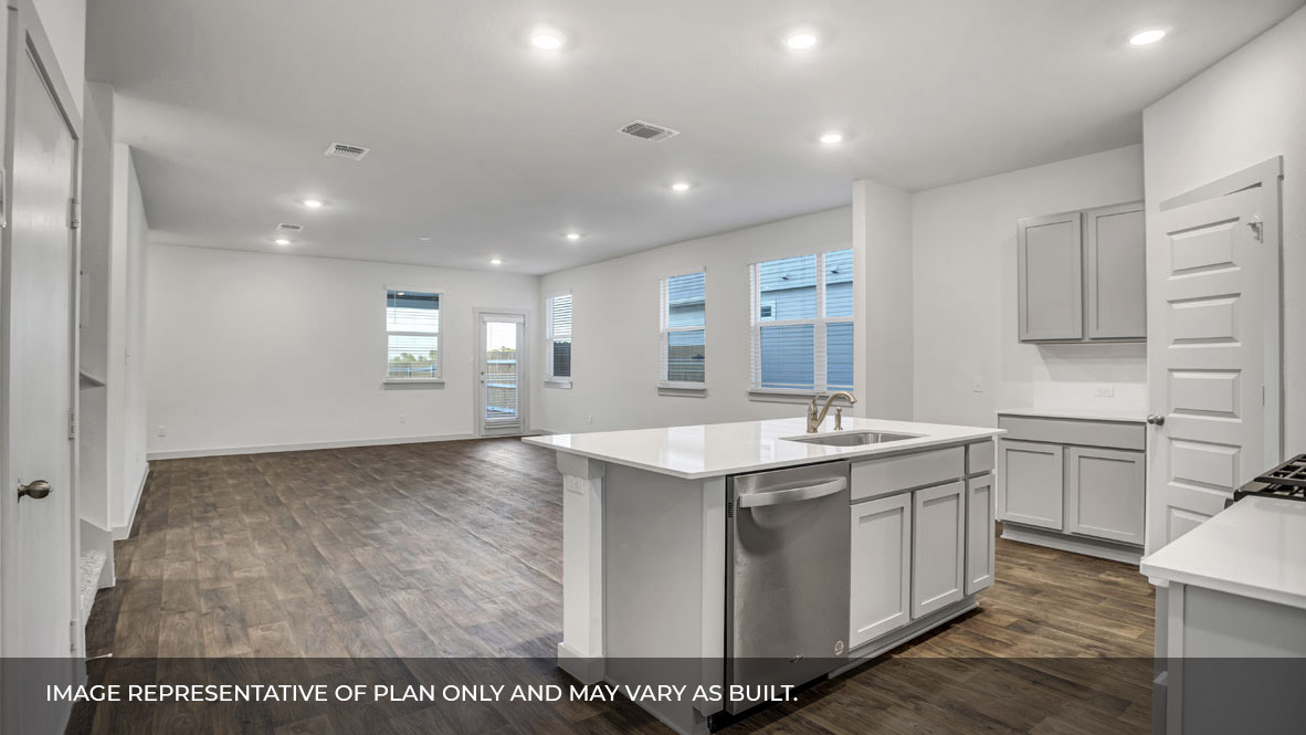 Open concept kitchen with large island with view of the living and and dining area.