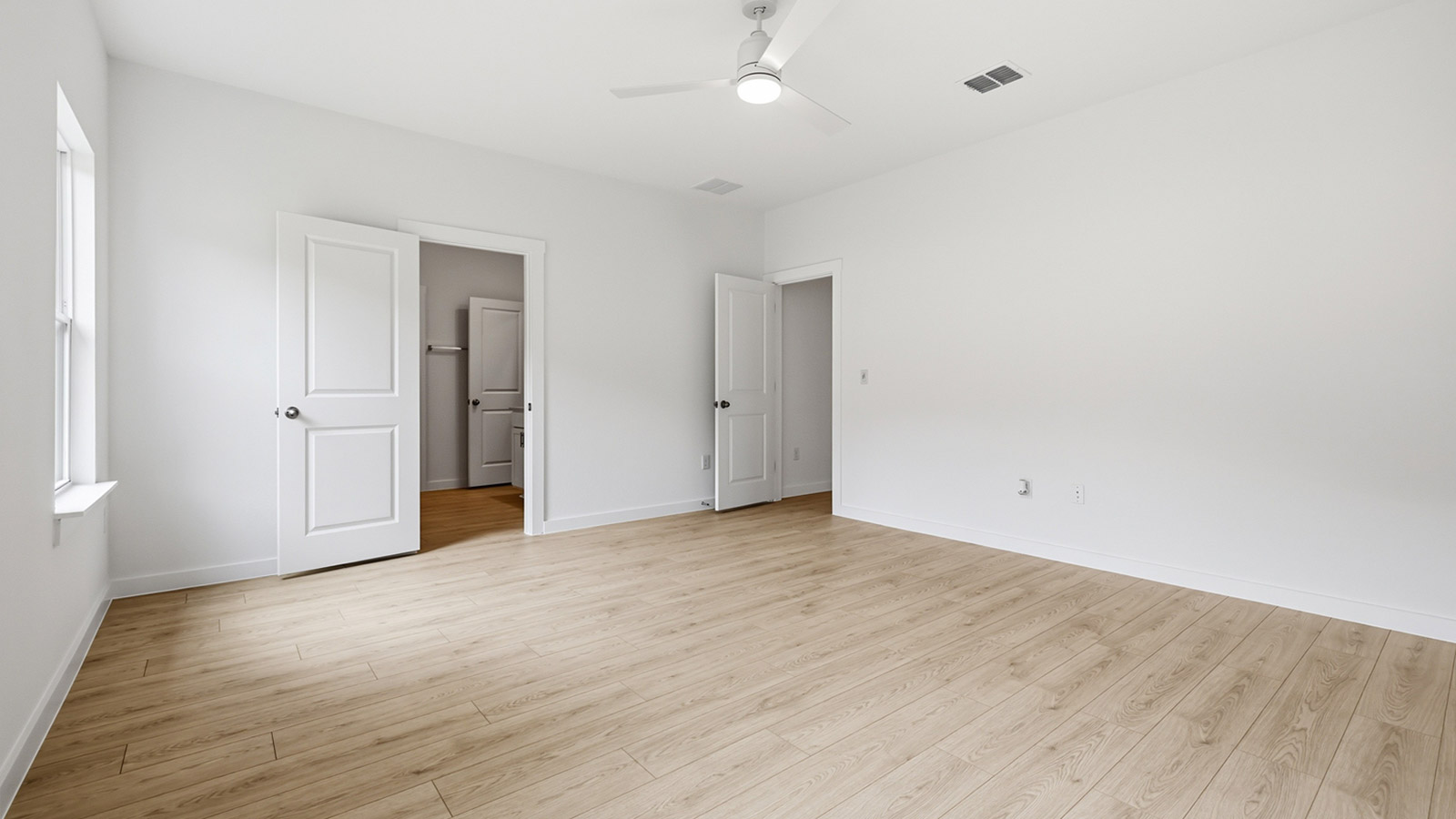 Premium laminate wood plank flooring in primary bedroom.
