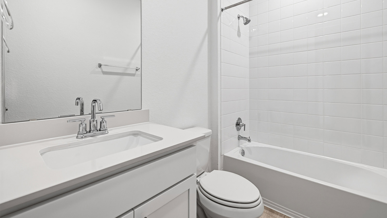Secondary bathroom with tub and raised shower head.