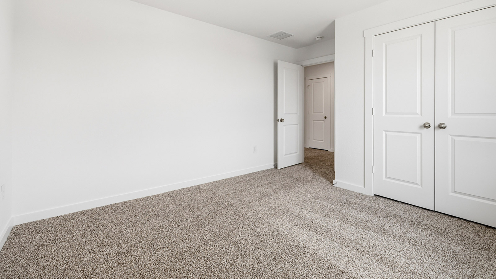 Bedroom 3 with carpeted flooring.