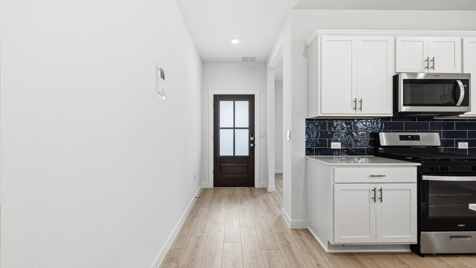 Entry way with view of mahogany wood front door.