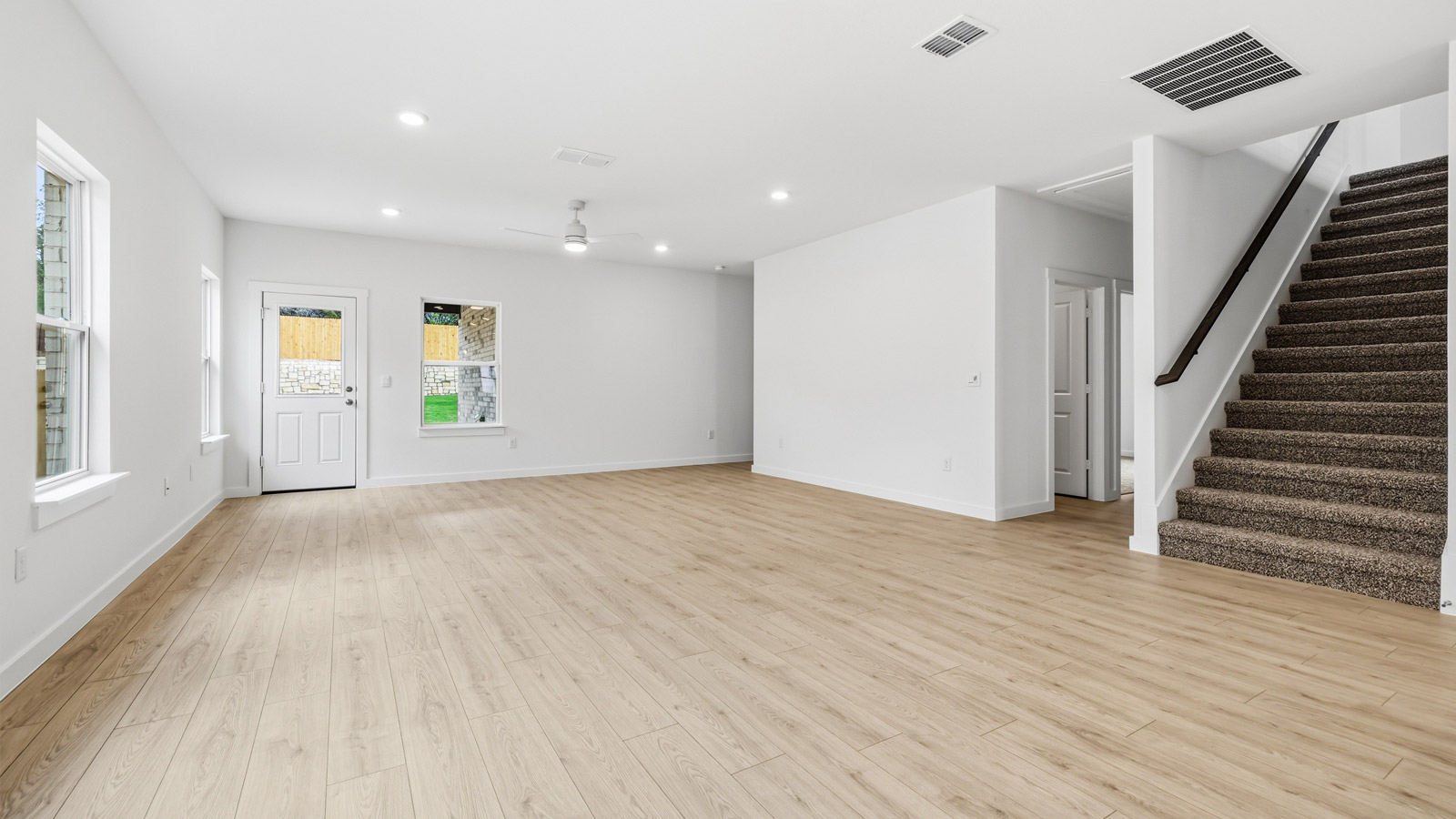 Living area with view of stairwell.