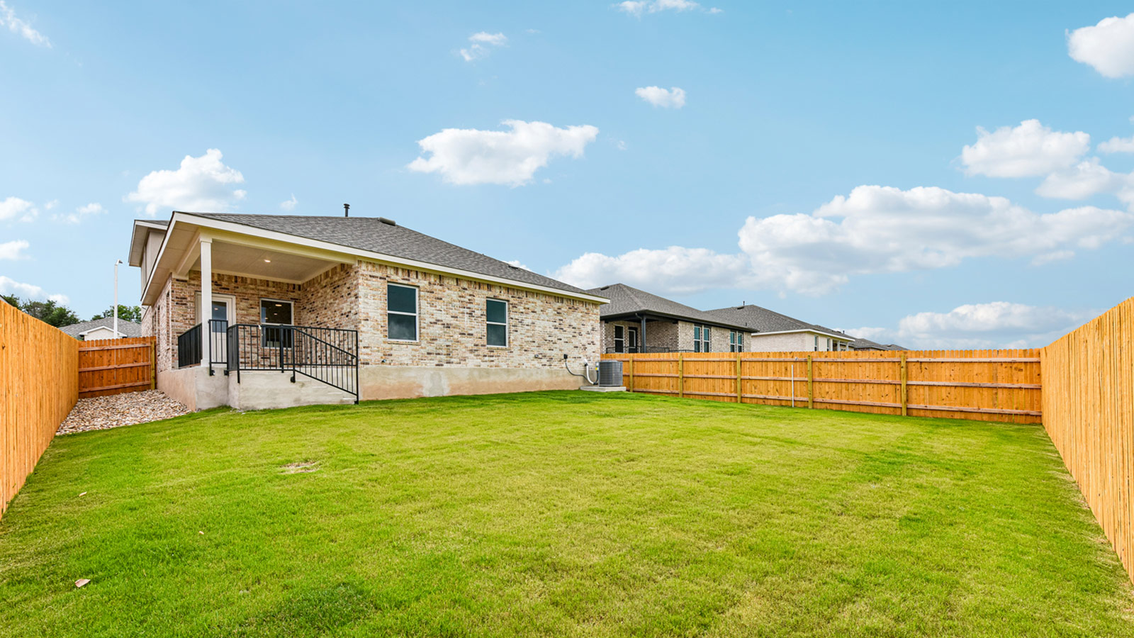 Large backyard of 1913 Lazy Acres Street in Leander, TX.