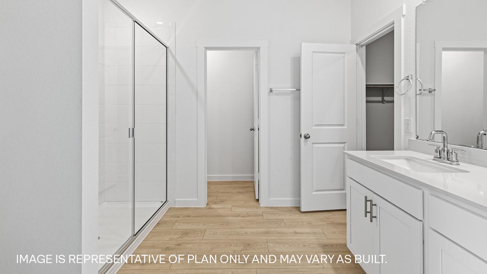 Luxurious main bathroom with quartz vanity and walk-in shower.