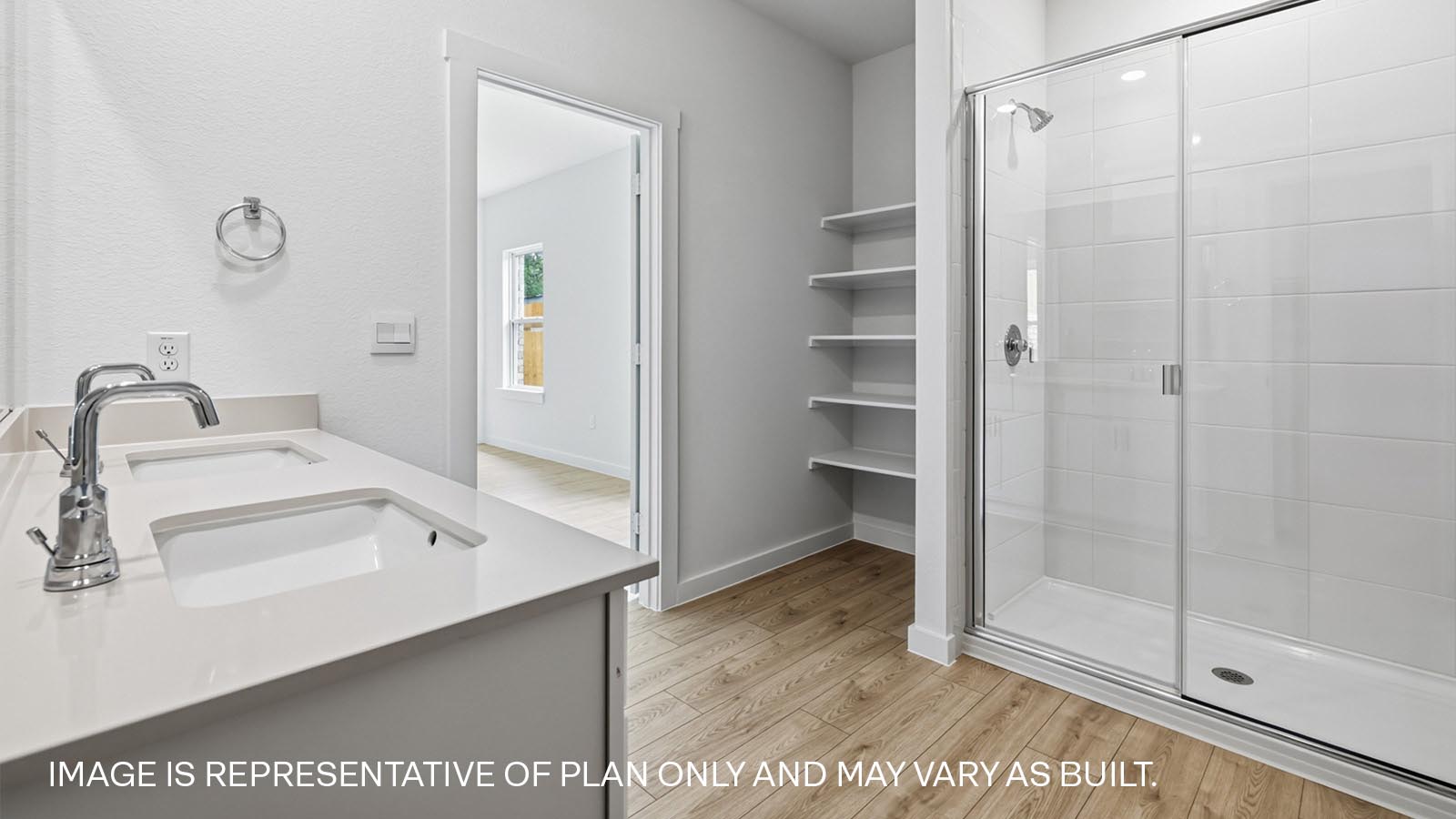 Dual vanity sink and walk-in shower in primary bathroom.