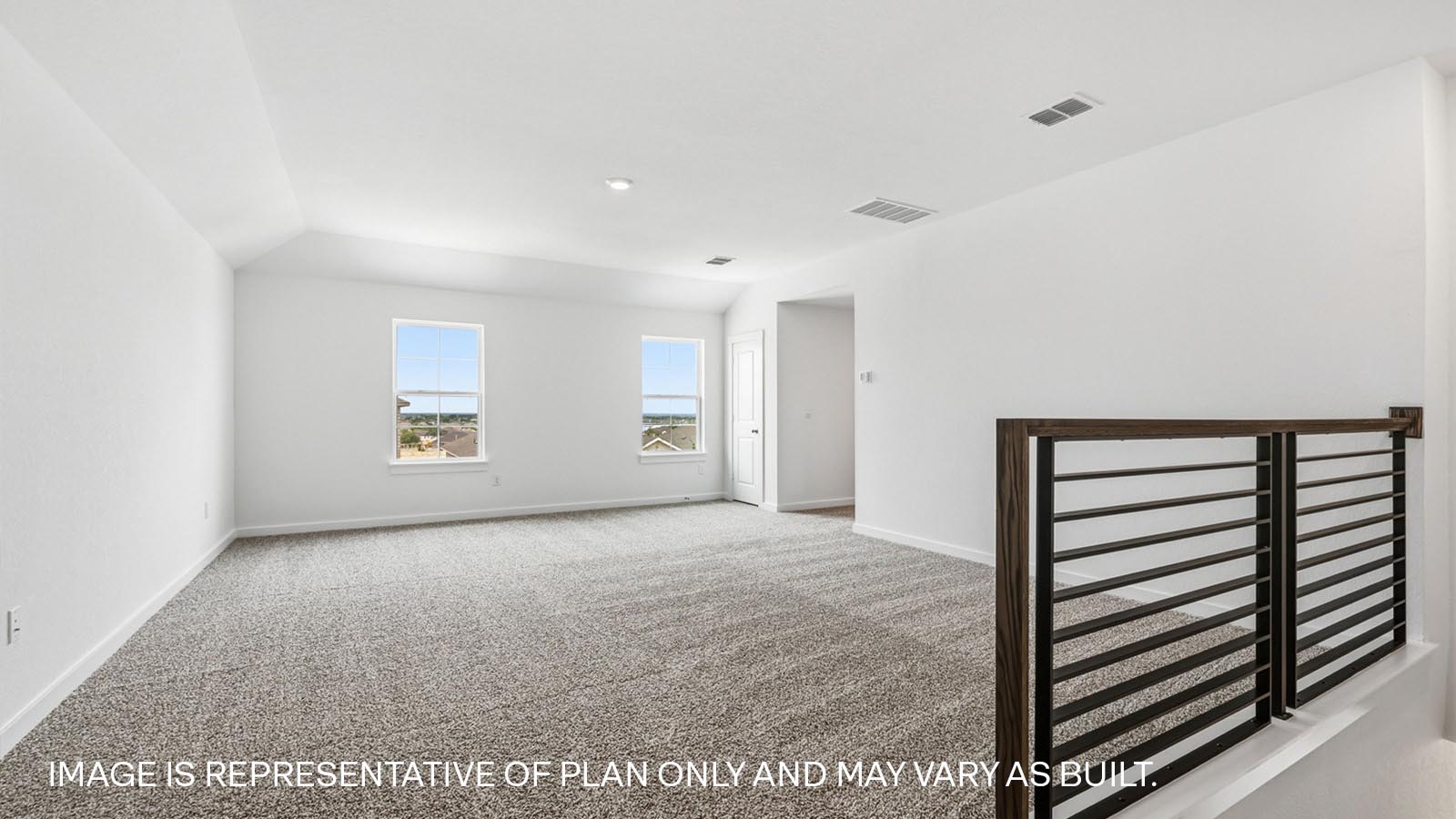 Upstairs game room with staircase and railing.
