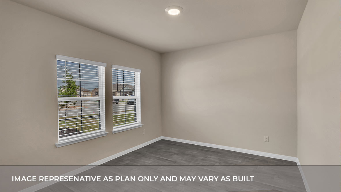 Bedroom with carpeted floors and two single windows for natural light.