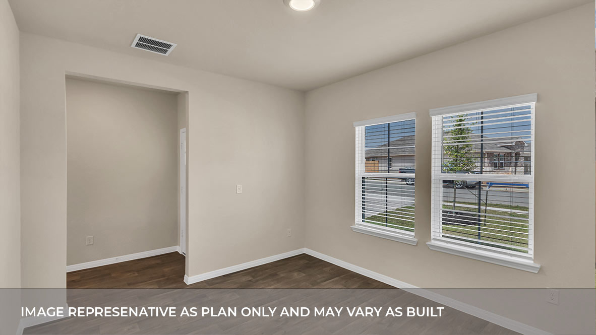 Bedroom with carpeted floors and two single windows for natural light.