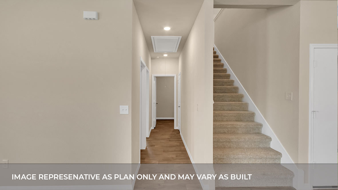 Hallway to bedrooms with stairs on the right.