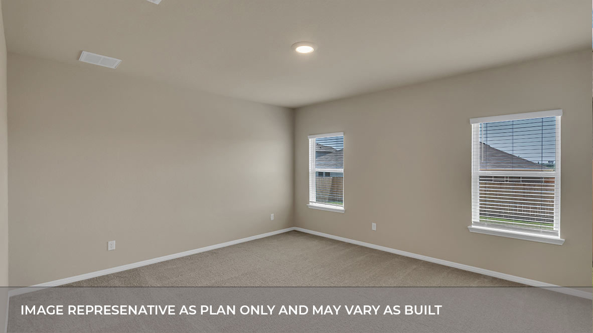 Primary bedroom with carpeted floors, two large windows, and trey ceilings.