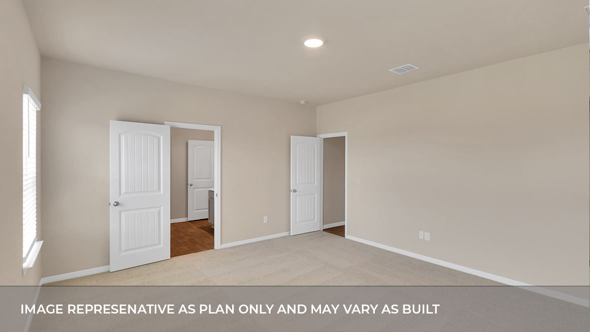Primary bedroom and door connecting the primary bathroom and entry door.