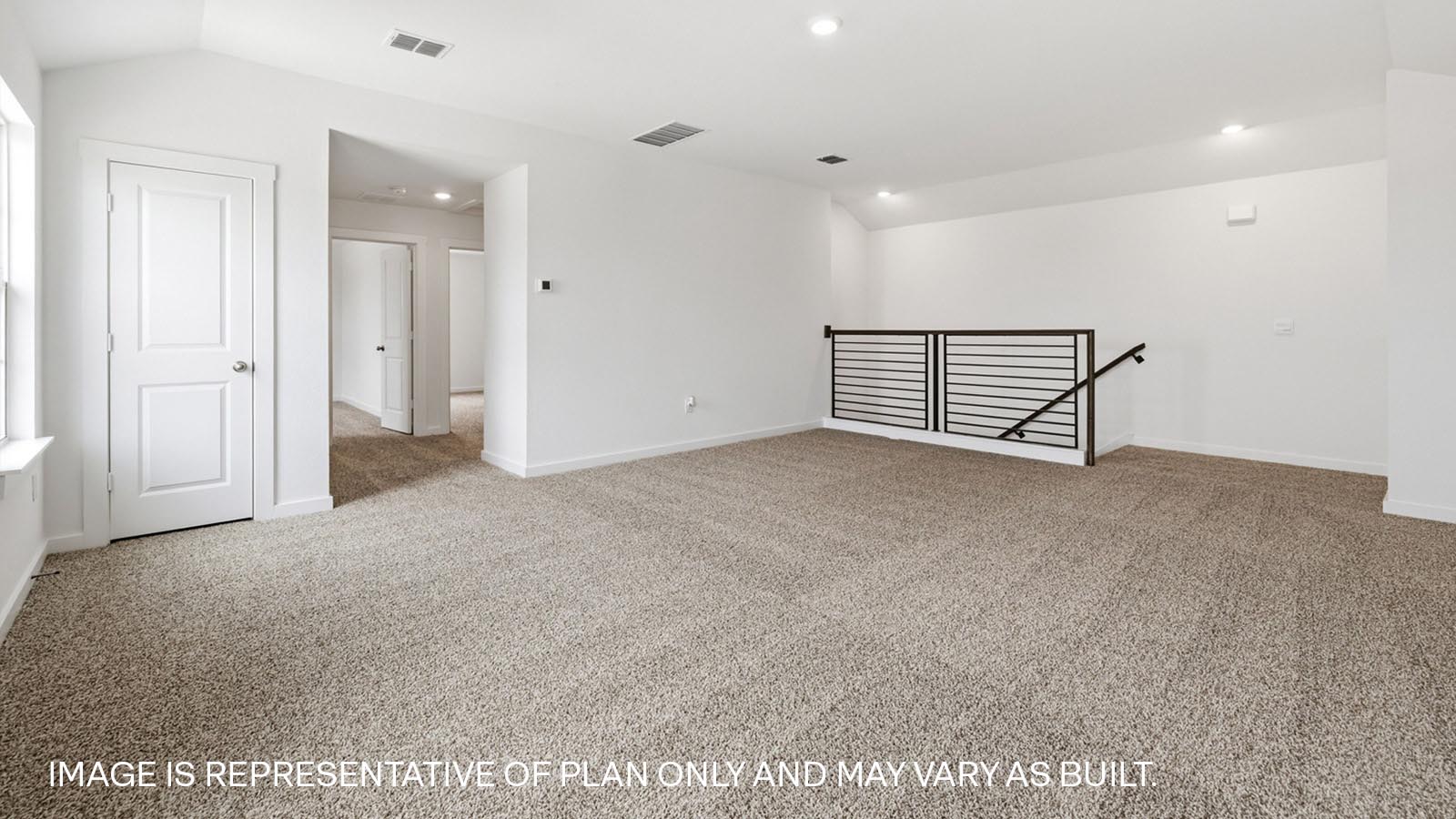 Spacious upstairs game room with carpeted flooring.