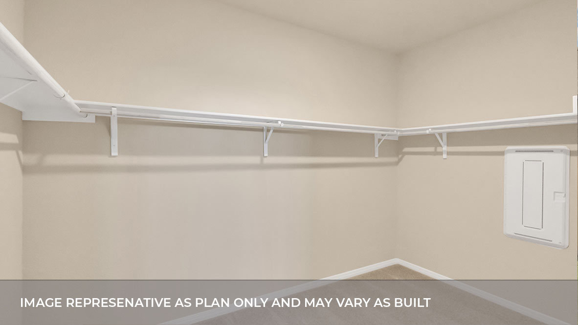 Spacious walk in closet with built in shelving in the primary bathroom.