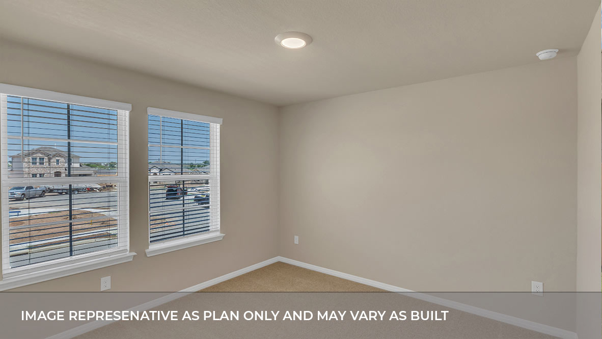 Bedroom with carpeted floors and two single windows for natural light.