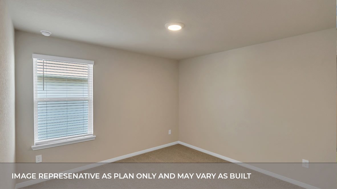 Bedroom with carpeted floors and large single window for natural light
