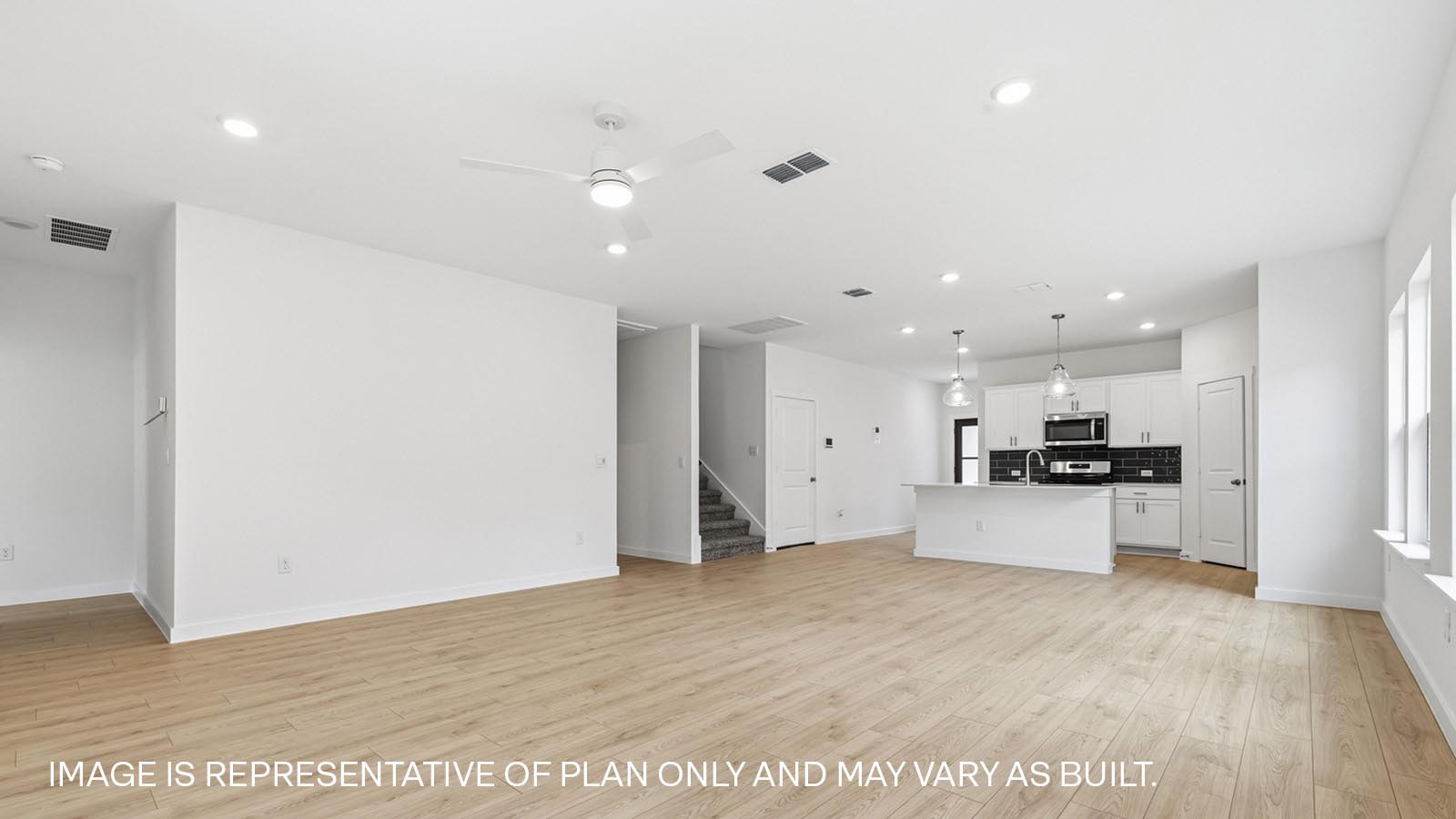 Open living area with premium wood plank flooring.