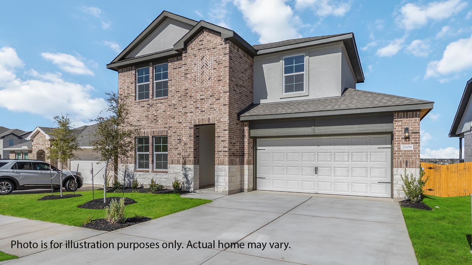 Front exterior two story Rosemont home with light tan brick, white paneling, and white siding with white two-car garage and driveway in the front with white shutters on the windows.