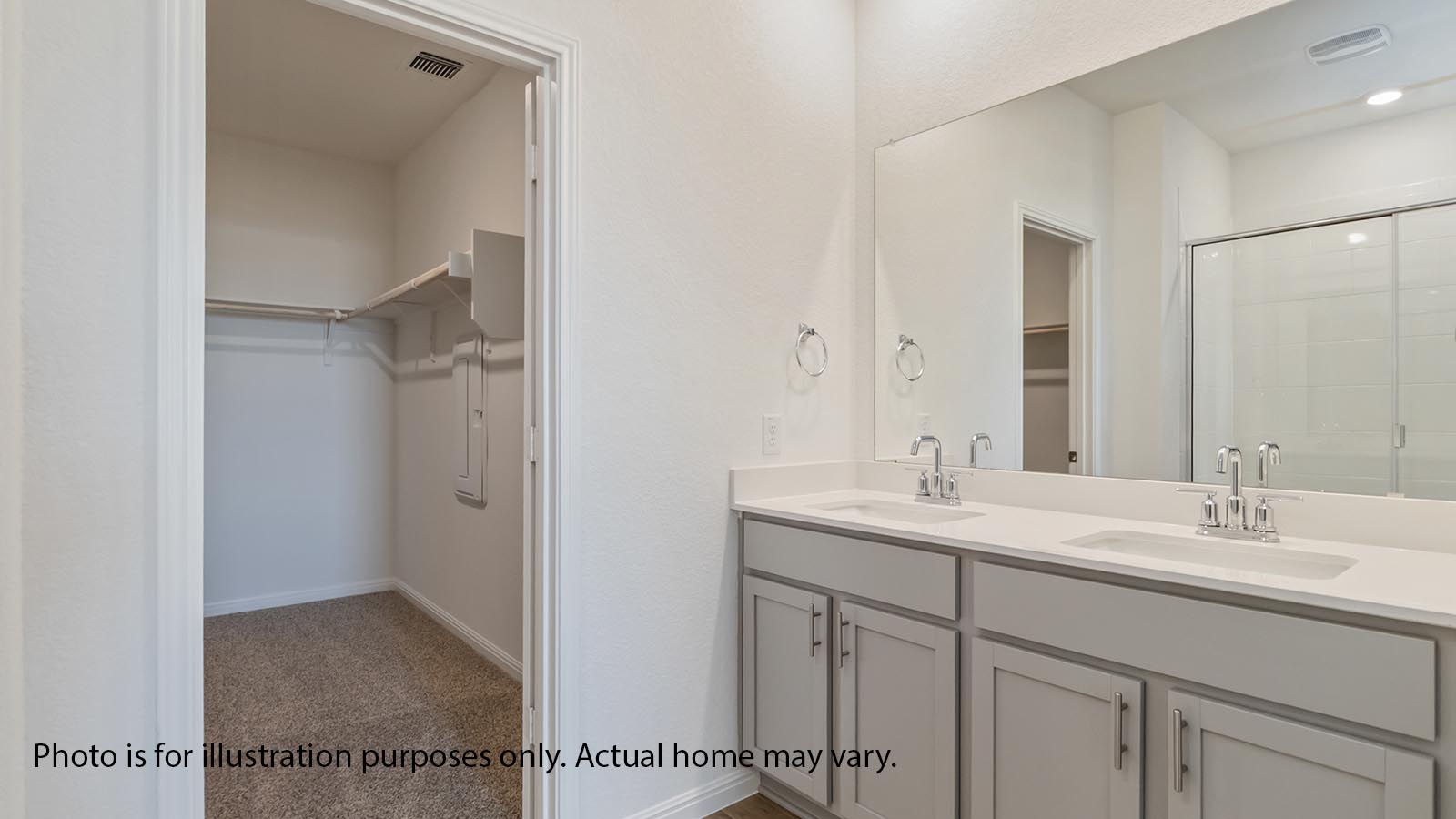 Primary bath with gray cabiets and dual sink and standing shower