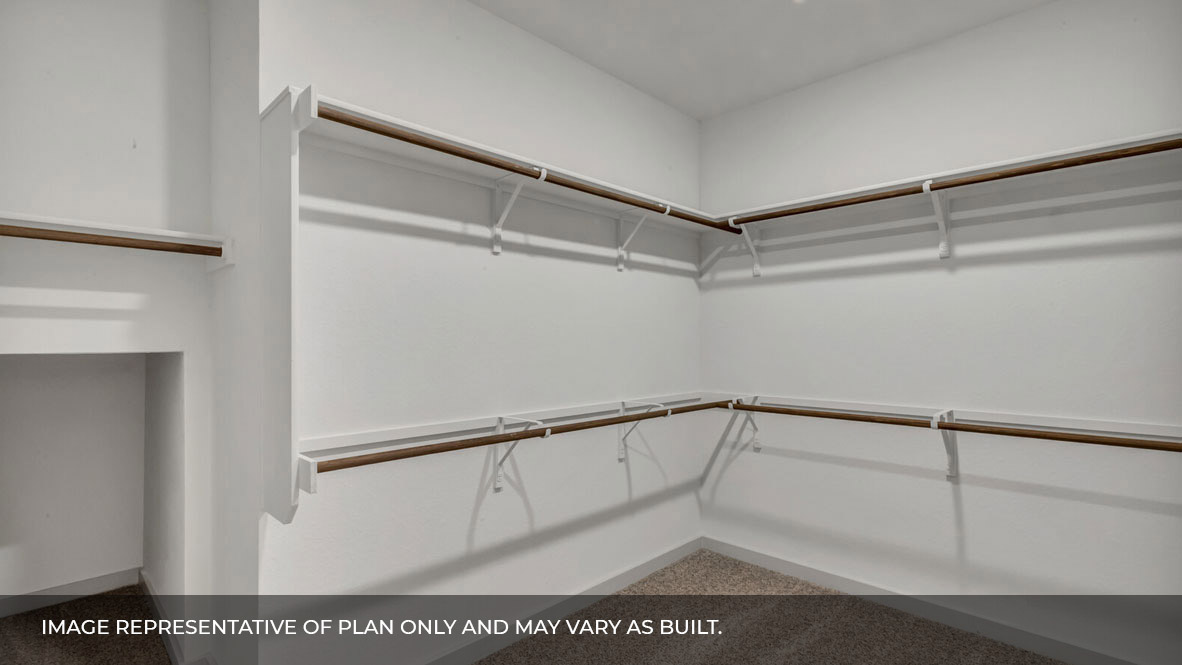 Spacious walk in closet with built in shelving in the primary bathroom.